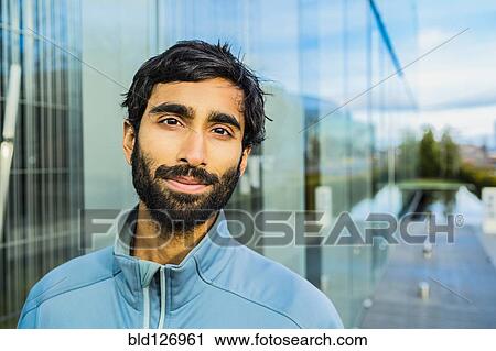 Stock Image - Portrait of smiling Indian man with beard. Fotosearch