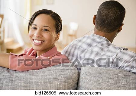 Portrait of woman smiling on sofa with boyfriend View Large Photo Image Stock Photography - Portrait of woman smiling on sofa with boyfriend. Fotosearch