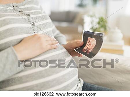 Pregnant Japanese woman holding ultrasound image View Large Photo Image Stock Image - Pregnant Japanese woman holding ultrasound image. Fotosearch
