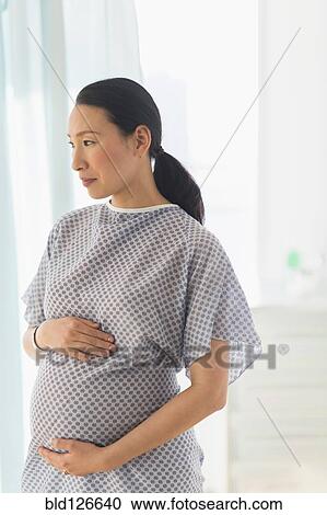 Pregnant Japanese woman in hospital gown View Large Photo Image Stock Image - Pregnant Japanese woman in hospital gown. Fotosearch