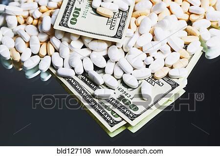 Prescription medication and one hundred dollar bills View Large Photo Image Stock Photo - Prescription medication and one hundred dollar bills. Fotosearch