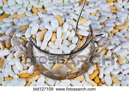 Stock Photo - Prescription medication overflowing from sugar bowl. Fotosearch