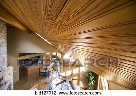 Slanted wood ceiling over living room and dining room View Large Photo Image Stock Image - Slanted wood ceiling over living room and dining room. Fotosearch