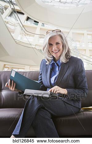 Stock Photography - Smiling Caucasian businesswoman using digital tablet. Fotosearch