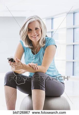Smiling Caucasian woman in sportswear with mp3 player View Large Photo Image Stock Photo - Smiling Caucasian woman in sportswear with mp3 player. Fotosearch