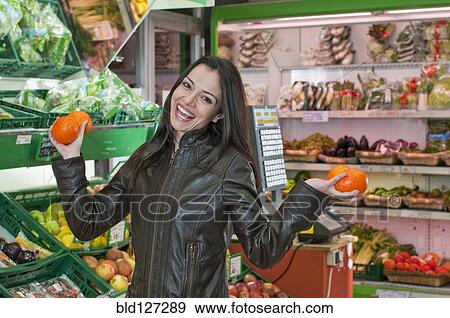 smiling woman with oranges in supermarket View Large Photo Image Stock Photo - smiling woman with oranges in supermarket. Fotosearch