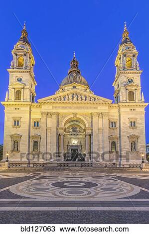 Stock Image - St. Stephen's Basilica illuminated at dusk, Budapest, Hungary. Fotosearch