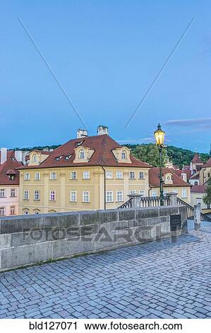 Stock Image - Streetlamp and cobblestone road at dawn, Prague, Czech Republic. Fotosearch
