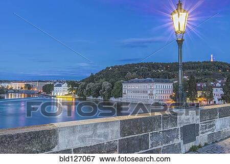 Streetlamp illuminated on Charles Bridge at dawn, Prague, Czech Republic View Large Photo Image Stock Photo - Streetlamp illuminated on Charles Bridge at dawn, Prague, Czech Republic. Fotosearch