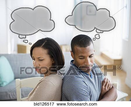 Stock Photo - Thought bubbles above frustrated couple. Fotosearch