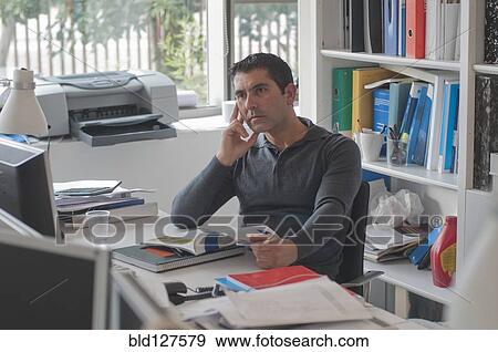 Stock Photo - tired office worker staring at computer screen. Fotosearch