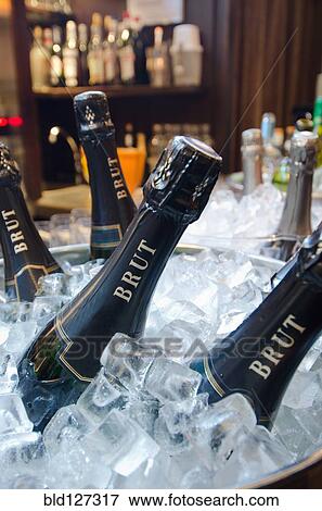 Stock Photo - Wine bottles in ice bucket in restaurant. Fotosearch