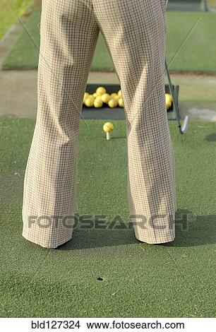 Picture - Woman practicing golf rear view low section. Fotosearch