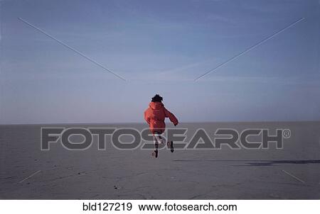 Woman running on sand flats rear view View Large Photo Image Stock Photo - Woman running on sand flats rear view. Fotosearch