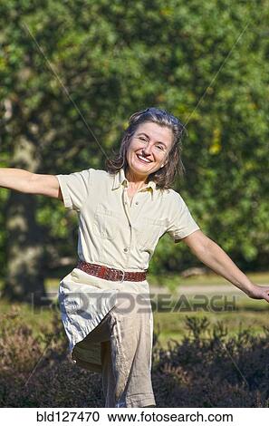 woman spreading arms in flying motion smiling View Large Photo Image Stock Image - woman spreading arms in flying motion smiling. Fotosearch