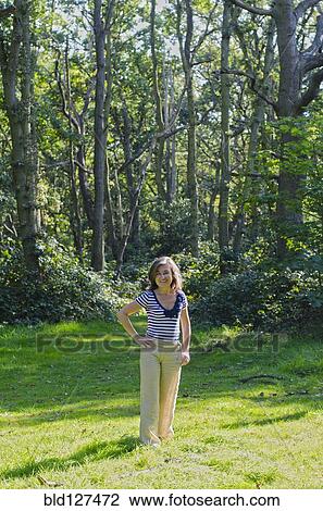 woman standing in clearing in forest View Large Photo Image Stock Image - woman standing in clearing in forest. Fotosearch