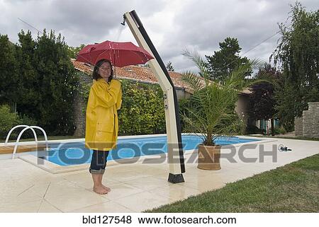woman with unbrella under outdoor shower View Large Photo Image Stock Photo - woman with unbrella under outdoor shower. Fotosearch