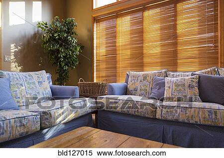 Wood blinds behind sofas in living room View Large Photo Image Stock Photography - Wood blinds behind sofas in living room. Fotosearch