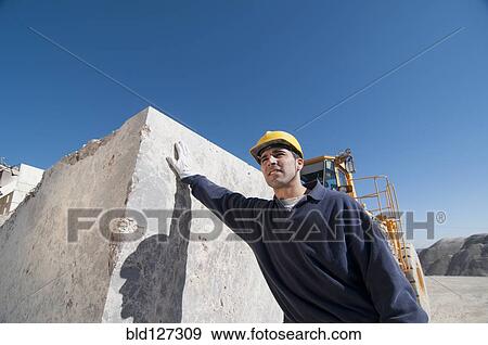 worker leaning against block of marble View Large Photo Image Stock Photo - worker leaning against block of marble. Fotosearch
