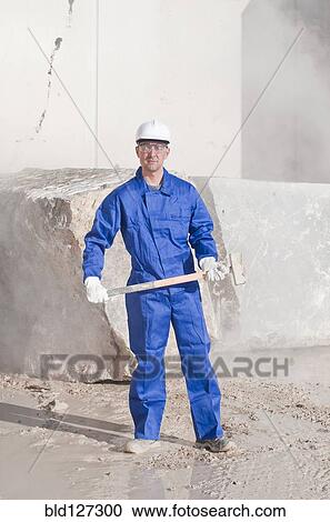 Stock Image - worker with sledgehammer. Fotosearch