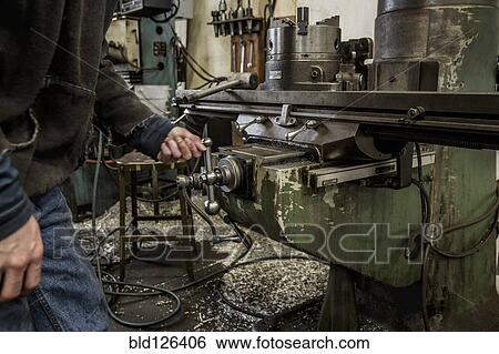 Working using machinery in metal shop View Large Photo Image Stock Photograph - Working using machinery in metal shop. Fotosearch