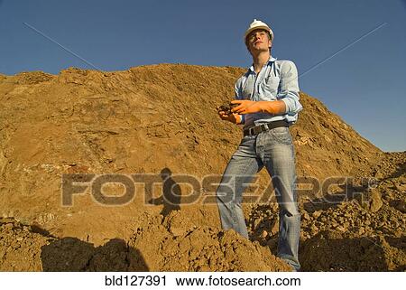 Young engineer checking soil samples on construction site View Large Photo Image Stock Image - Young engineer checking soil samples on construction site. Fotosearch