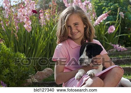 young girl with dog in garden View Large Photo Image Stock Image - young girl with dog in garden. Fotosearch