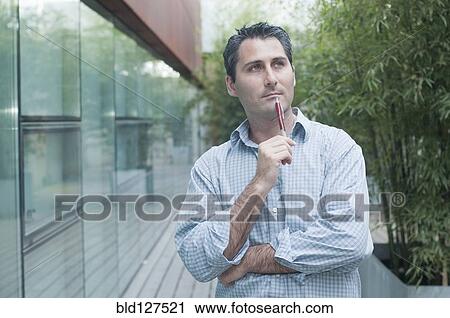 young man looking pensively into distance View Large Photo Image Stock Image - young man looking pensively into distance. Fotosearch