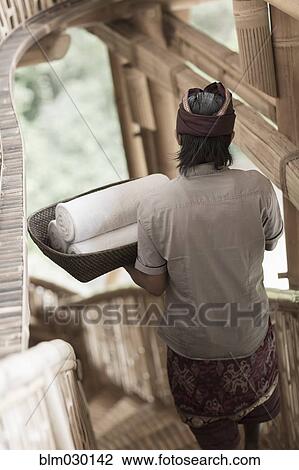 Balinese man carrying rolled towels in hotel, Ubud, Bali, Indonesia View Large Photo Image Stock Image - Balinese man carrying rolled towels in hotel, Ubud, Bali, Indonesia. Fotosearch