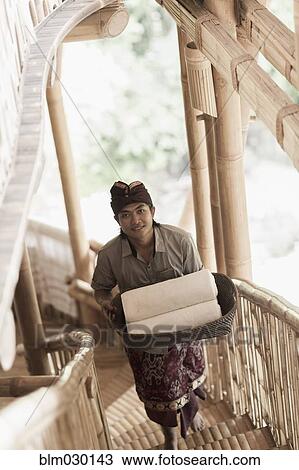 Balinese man carrying rolled towels in hotel, Ubud, Bali, Indonesia View Large Photo Image Stock Image - Balinese man carrying rolled towels in hotel, Ubud, Bali, Indonesia. Fotosearch