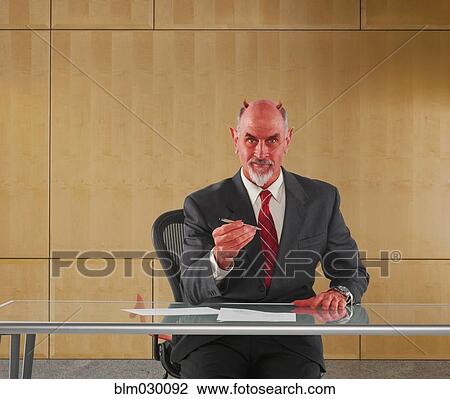 Caucasian businessman in devil costume offering pen to sign contract View Large Photo Image Stock Image - Caucasian businessman in devil costume offering pen to sign contract. Fotosearch