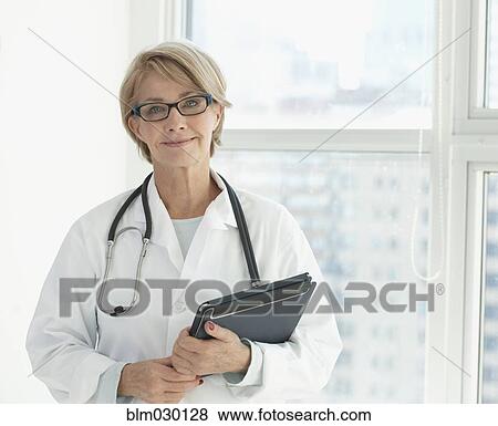 Caucasian doctor using digital tablet in hospital View Large Photo Image Stock Photo - Caucasian doctor using digital tablet in hospital. Fotosearch