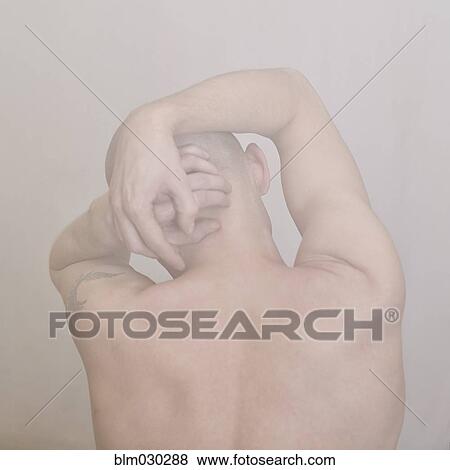 Stock Photo - Caucasian man clutching his head. Fotosearch