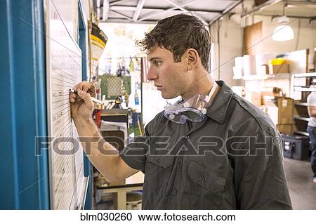 Caucasian worker writing on whiteboard in warehouse View Large Photo Image Stock Image - Caucasian worker writing on whiteboard in warehouse. Fotosearch