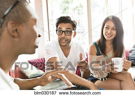 Stock Photo - Friends hanging out at cafe. Fotosearch