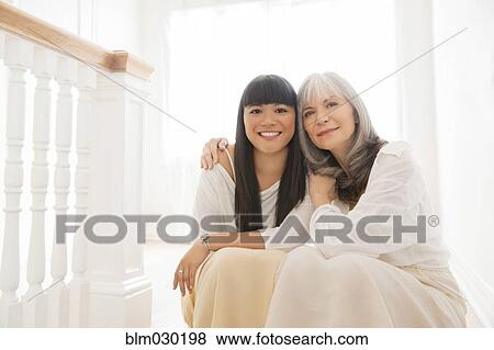 Mother and daughter hugging on steps View Large Photo Image Stock Photo - Mother and daughter hugging on steps. Fotosearch