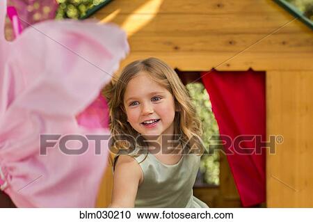 Smiling girl in playhouse View Large Photo Image Stock Image - Smiling girl in playhouse. Fotosearch