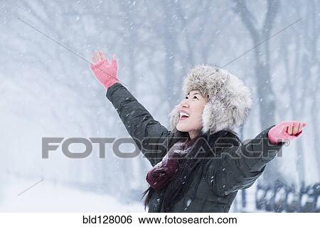 Asian woman cheering in snow View Large Photo Image Stock Photograph - Asian woman cheering in snow. Fotosearch