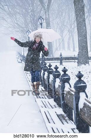 Asian woman walking on benches in snowy Central Park, New York City, New York, United States View Large Photo Image Stock Image - Asian woman walking on benches in snowy Central Park, New York City, New York, United States. Fotosearch
