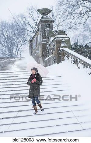 Asian woman walking on snowy steps View Large Photo Image Stock Photo - Asian woman walking on snowy steps. Fotosearch