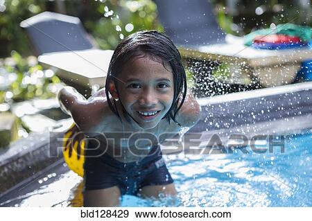 Balinese boy playing in swimming pool View Large Photo Image Stock Photo - Balinese boy playing in swimming pool. Fotosearch