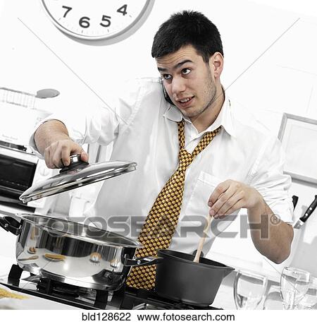 Caucasian businessman cooking in kitchen View Large Photo Image Stock Image - Caucasian businessman cooking in kitchen. Fotosearch