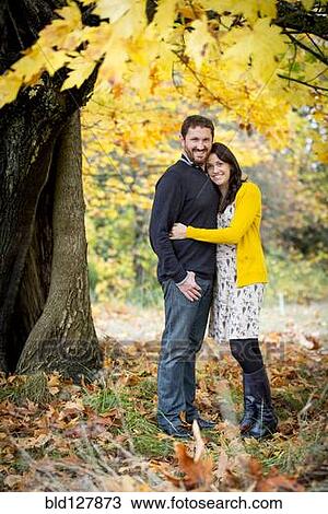 Stock Image - Caucasian couple hugging in park. Fotosearch