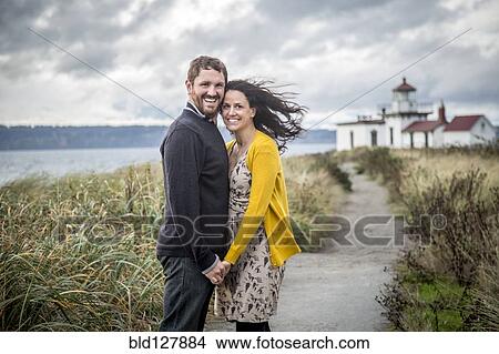 Caucasian couple hugging on beach path View Large Photo Image Picture - Caucasian couple hugging on beach path. Fotosearch