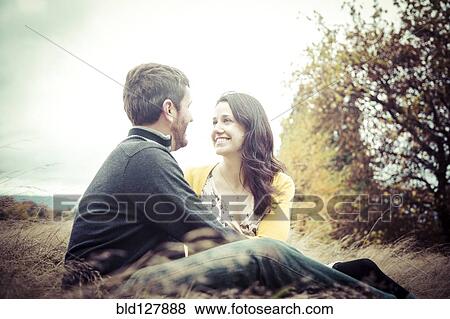 Caucasian couple sitting outdoors View Large Photo Image Stock Photo - Caucasian couple sitting outdoors. Fotosearch