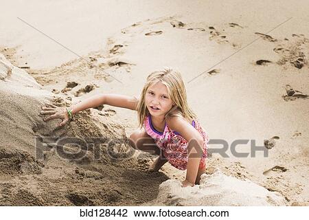 Caucasian girl climbing sand hill on beach View Large Photo Image Stock Image - Caucasian girl climbing sand hill on beach. Fotosearch