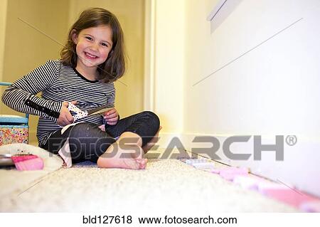 Caucasian girl crafting in playroom View Large Photo Image Stock Photo - Caucasian girl crafting in playroom. Fotosearch