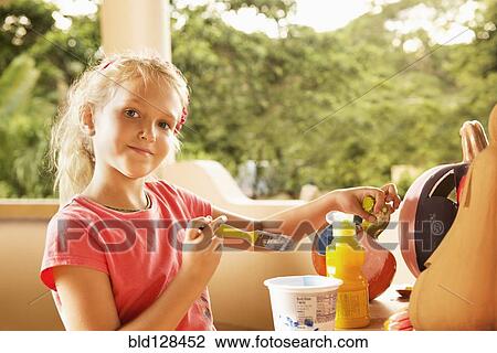 Caucasian girl decorating jack o'lantern View Large Photo Image Stock Image - Caucasian girl decorating jack o'lantern. Fotosearch