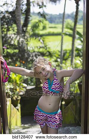Stock Photo - Caucasian girl smiling in tropical rainforest. Fotosearch