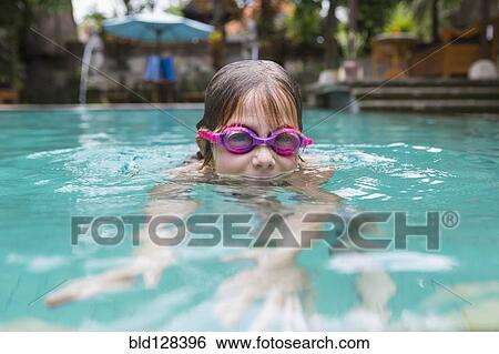 Stock Photograph - Caucasian girl swimming in pool. Fotosearch